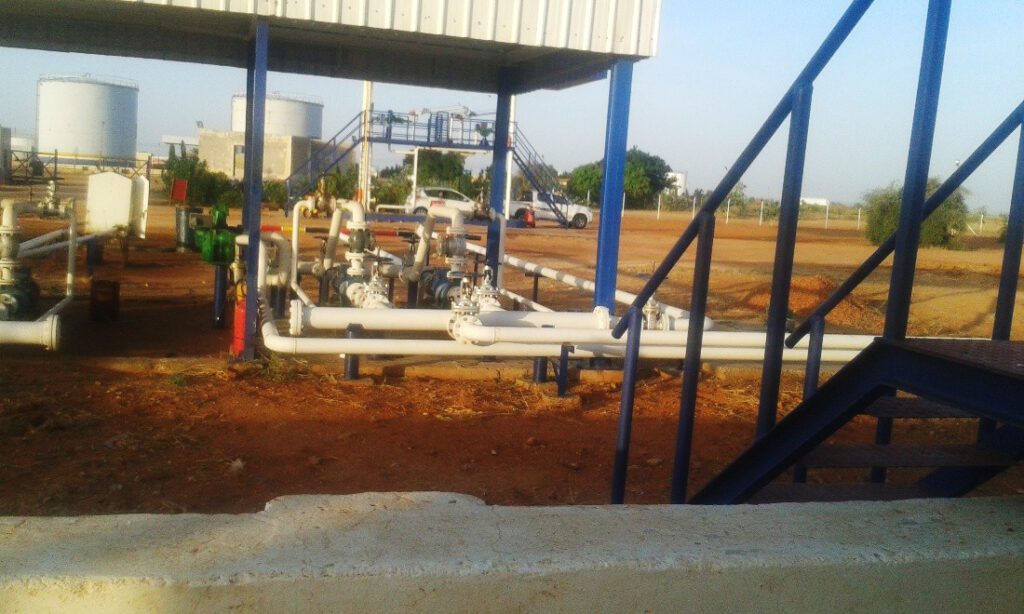 The Flow Control Area features white-coated transportation pipes to enhance thermal insulation, with metal access platforms for logistics operations.