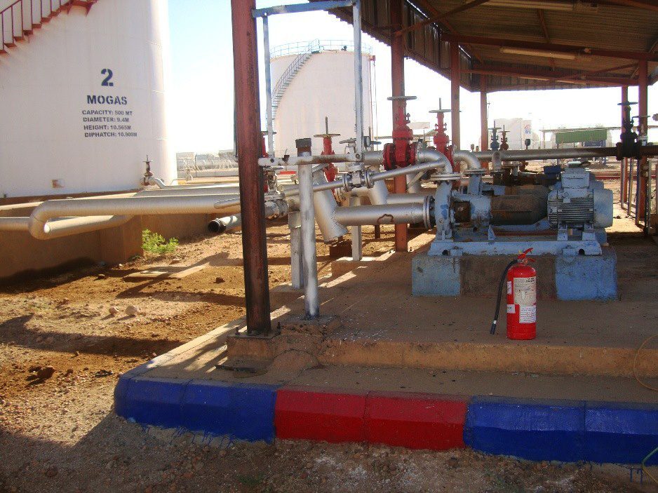 A mechanical pumping unit equipped with an electric motor and turbine for transporting petroleum materials, located under a protective canopy next to the engine fuel tank, with safety and fire-fighting equipment available on site.