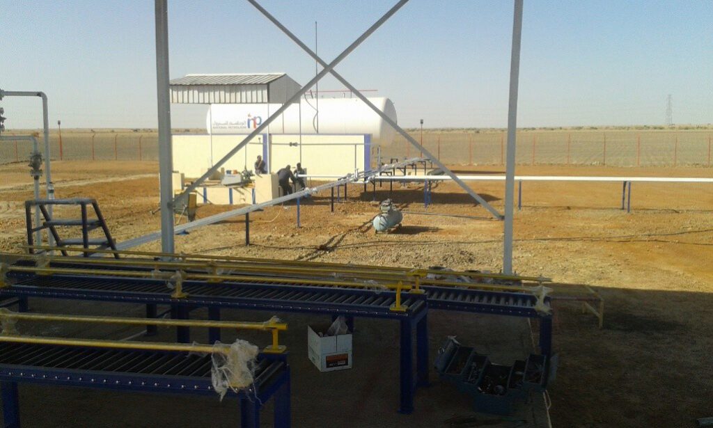 The operations yard at the Kosti warehouse shows the work of installing the final connections to the pipe network connecting the storage tanks and the filling platform, with technical work crews present on site.